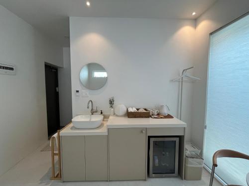 a bathroom with a sink and a mirror at 까사뚜아 Casa Tua in Sokcho