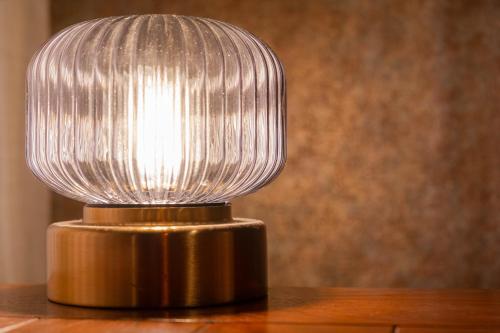 a glass lamp on top of a wooden table at WaKaRaN9111 和華蘭文化を体感! 長崎情緒あふれる一軒家 in Nagasaki