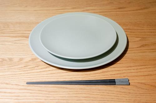 a white plate and a chopstick on a wooden table at WaKaRaN9111 和華蘭文化を体感! 長崎情緒あふれる一軒家 in Nagasaki