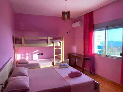 a bedroom with two bunk beds and a window at Meti Guest House in Krujë