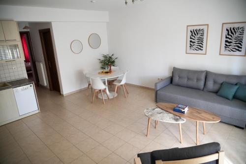 a living room with a couch and a table at Meltemi by GG in Alexandroupoli
