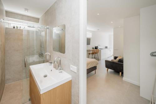 a bathroom with a sink and a shower and a bathroom with a tub at The Dune gate in Zandvoort