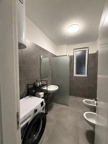 a bathroom with two sinks and two toilets at BR Tale in Lezhë