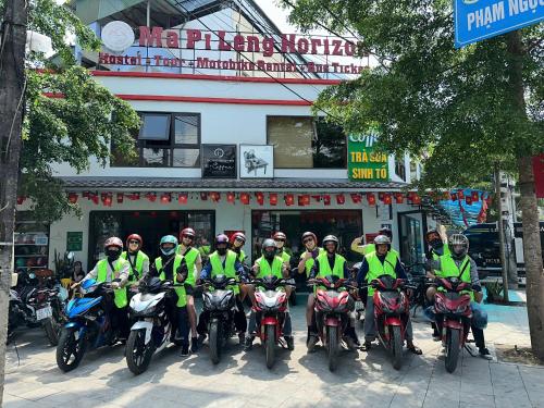 a group of people on motorcycles in front of a building at Ma Pi Leng Horizon Hostel - Tour & Motobike rental in Ha Giang
