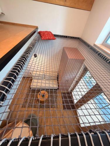 a dog in a cage in a room at Tiny Folk in Gărâna
