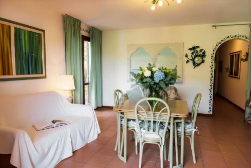 a living room with a table and chairs at Appartamento Monte Ladu in Porto Rotondo