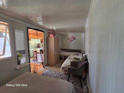 a small bedroom with a bed and a room with a table at Royal hammock-Kralski hamak in Chernomorets