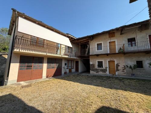 an exterior view of a house with a yard at La Ca d'Marietta in Paesana
