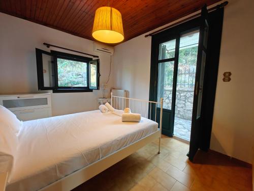 a bedroom with a large bed and a large window at Nikiana Panorama in Nikiana