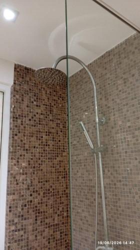 a shower with a glass door in a bathroom at Nam Talay Condo Monthly only in Na Jomtien