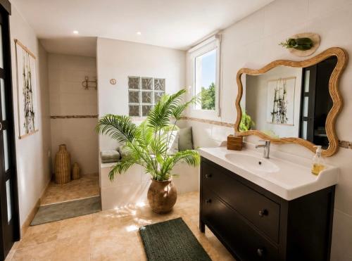 a bathroom with a sink and a mirror at La Bastide de Grosille in Savasse