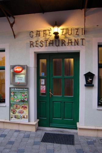 a green door on the front of a restaurant at Penzión Zuzi in Trenčianske Teplice