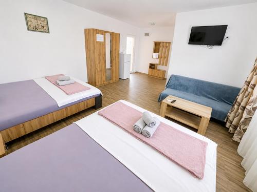 a living room with two beds and a couch at Casa Olimpia 2 Mai in 2 Mai