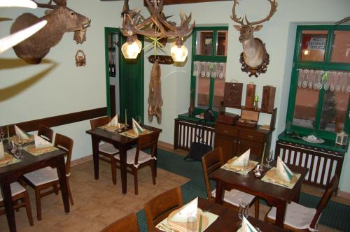 a restaurant with tables and chairs with deer heads on the wall at Penzión Zuzi in Trenčianske Teplice
