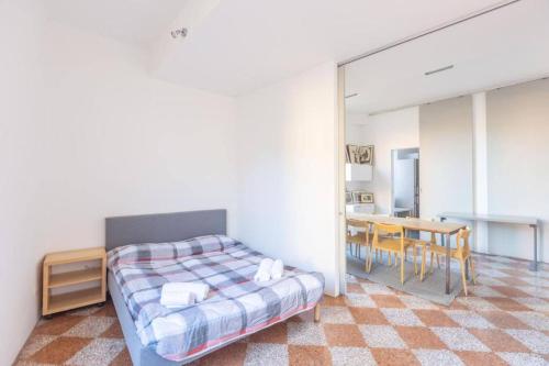 a bedroom with a bed and a dining room at Nel Ghetto, Bologna by Short Holidays in Bologna