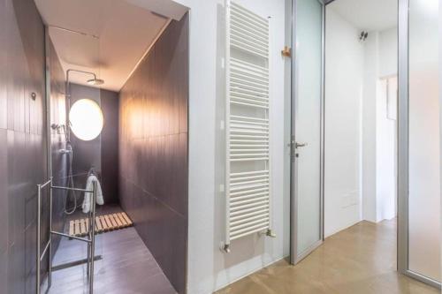 a bathroom with a walk in shower and a glass door at Nel Ghetto, Bologna by Short Holidays in Bologna