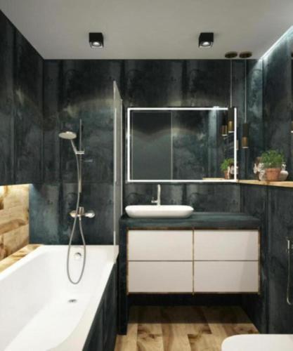 a bathroom with a tub and a sink and a bath tub at Skyline Grand Hotel - Near IGI New Delhi Airport in New Delhi