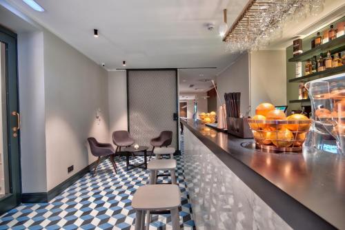 a restaurant with chairs and a counter with oranges on it at La Falconeria Hotel in Valletta