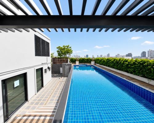 a swimming pool on the roof of a house at CONDO UNIT With BALCONY in Bangkok