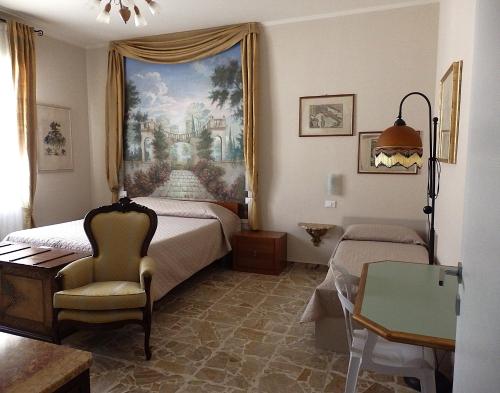 a bedroom with a bed with a painting on the wall at Riflessi d'Arte in Provaglio d'Iseo
