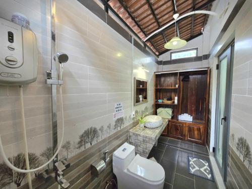 a bathroom with a toilet and a sink at Fla Village in Phú Quốc