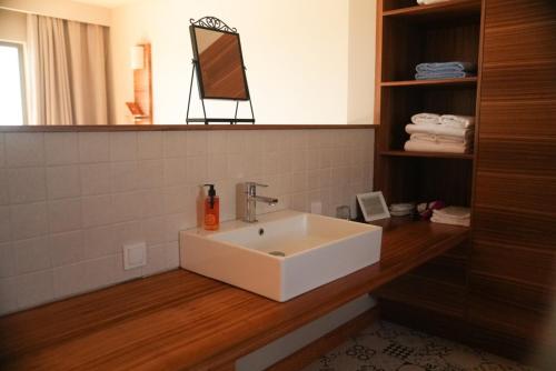 a bathroom with a white sink and a mirror at Bakucha Vineyard Hotel ve Spa in Lüleburgaz