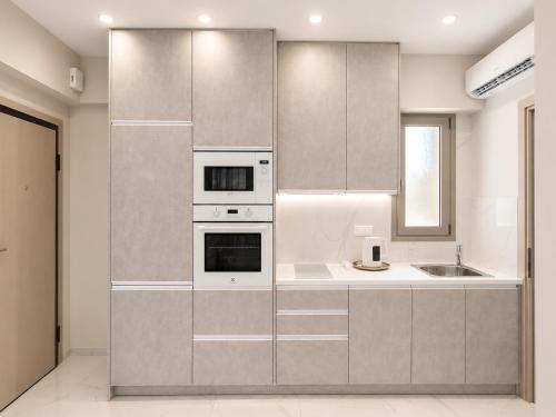 a kitchen with stainless steel appliances and a sink at AGORA luxury APARTMENT 3 in Loutraki