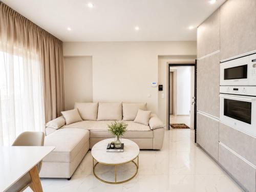 a living room with a couch and a table at AGORA luxury APARTMENT 3 in Loutraki