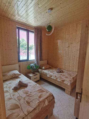 a room with two beds and a window at Levani Cottages in Ureki