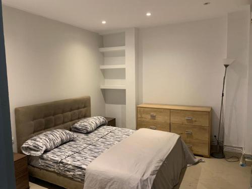 a bedroom with a bed with two pillows on it at Appartement familial centre de Hydra in Hydra