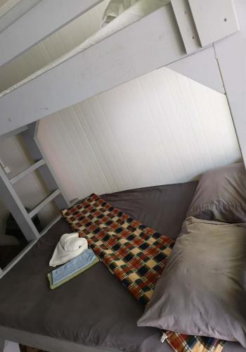 a bed with a blanket and a book on it at GoodWorks Accommodation in Yangor