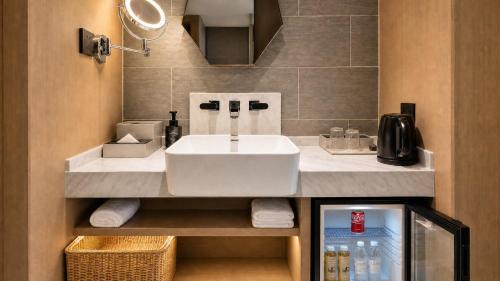 a bathroom with a white sink and a mirror at Atour on the Bund in Shanghai