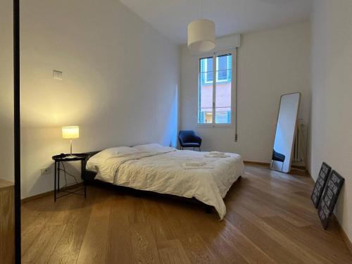 a bedroom with a bed and a desk and a mirror at Porta Nova, Bologna by Short Holidays in Bologna