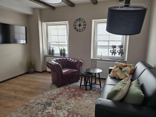 a living room with a couch and a chair at Excellent house in Ediger-Eller
