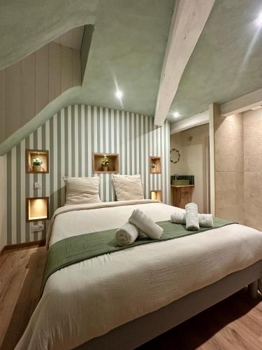 a bedroom with a large bed with towels on it at Les 4 Horizons in Romorantin
