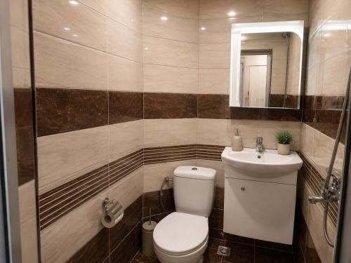 a bathroom with a toilet and a sink at Comfortable Room in The City Centre in Varna City