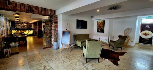 a living room with chairs and a table in it at TERRA penzión in Jasová