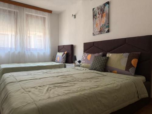 a bedroom with two beds and a window at Eva apartment in Ohrid