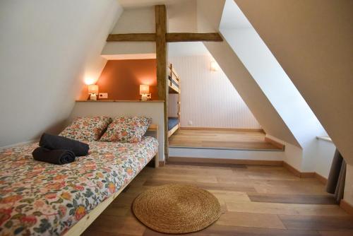 a bedroom with a bed and a stair case at Chez Marcel et Louise in Chinon