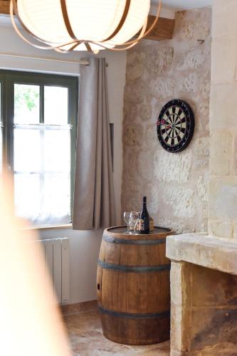 a room with a barrel and a dartboard on the wall at Chez Marcel et Louise in Chinon