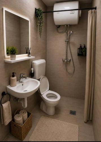 a bathroom with a toilet and a sink and a mirror at Katun Mokra in Podgorica