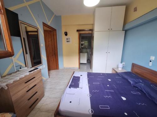 a bedroom with a bed and a dresser and cabinets at Vangel Garden in Agios Nikolaos
