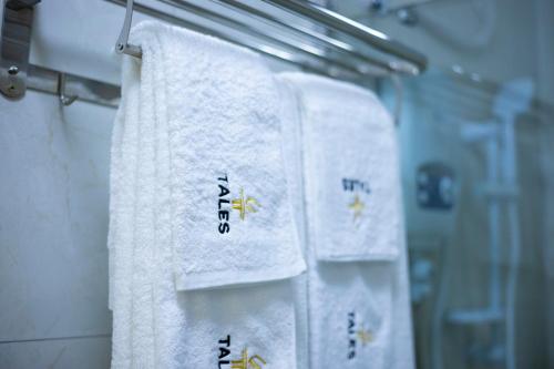 a row of towels on a rack in a bathroom at Tales Luxury in Kampala