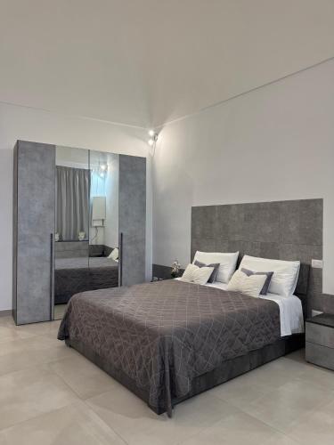 a bedroom with a large bed and a large mirror at Longhome in Pompei