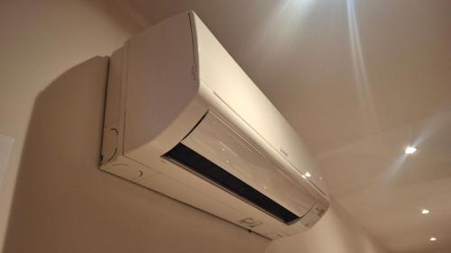 a white microwave oven hanging from a ceiling at Arvén Crimson in Marghera