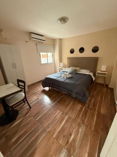 a bedroom with a bed and a wooden floor at Del Fundador in Córdoba