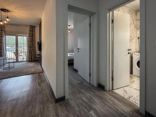 a hallway with white doors and a bathroom at Seaside Village in Kamenari