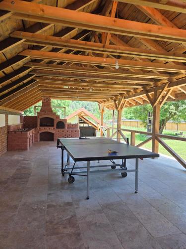 a ping pong table in the middle of a pavilion at Cuib de Munte in Brezoi