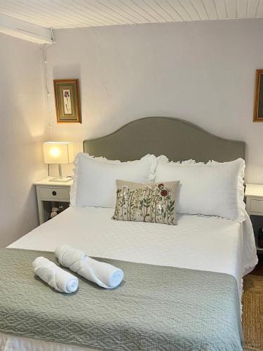 a bedroom with a bed with two slippers on it at Casa da Juana in Chantada