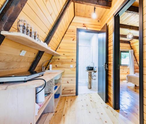 a kitchen in a log cabin with a wooden ceiling at Hatsvali Gate in Mestia